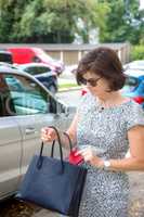 Woman next to car on the street