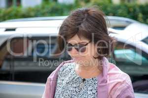 Woman next to car on the street