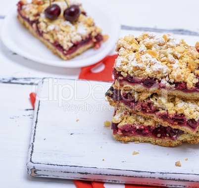 stack of baked slices of a pie with cherry berries