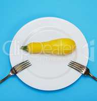 raw yellow squash in a white ceramic plate
