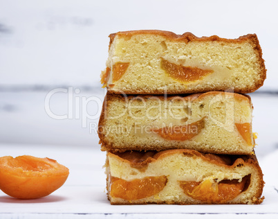 a stack of baked square slices of a biscuit pie with apricots