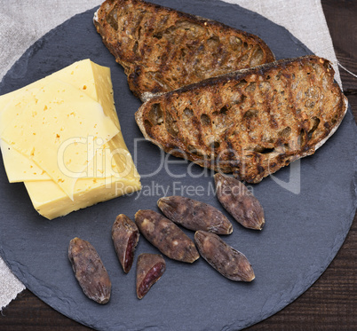 pieces of smoked salami, cheese and toast from bread
