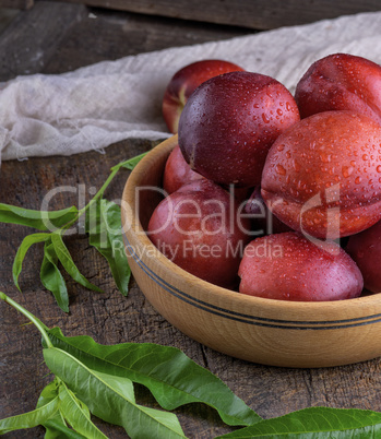 ripe peaches nectarine in a brown wooden bowl