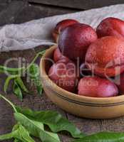ripe peaches nectarine in a brown wooden bowl