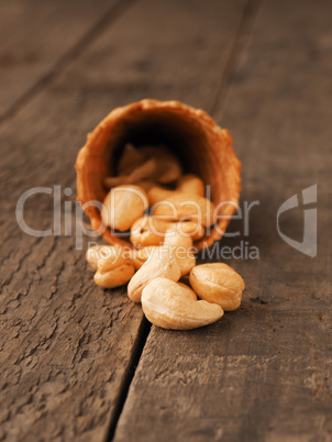 Organic cashews with ice cream cone on wood