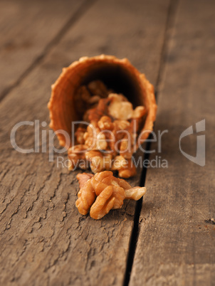 Organic walnuts with ice cream cone on wood