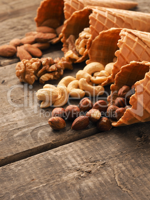Organic nuts with ice cream cones on wood