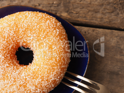 Tasty sweet donut on a rustic wooden table