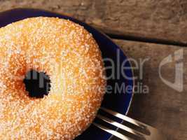 Tasty sweet donut on a rustic wooden table