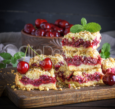 square slice of crumble pie with cherry