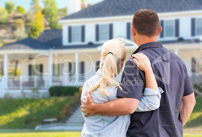 Young Adult Couple Facing Front of Beautiful House