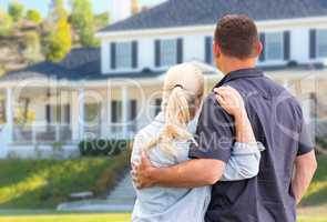 Young Adult Couple Facing Front of Beautiful House