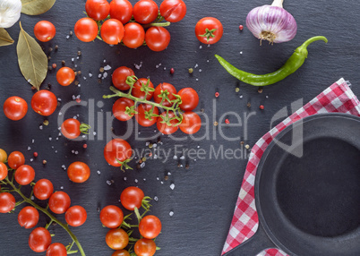 cherry tomatoes , next to the empty round black frying pan