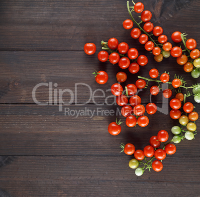 ripe red cherry tomatoes on a brown wooden board