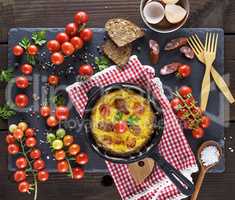 black round frying pan with fried omelette