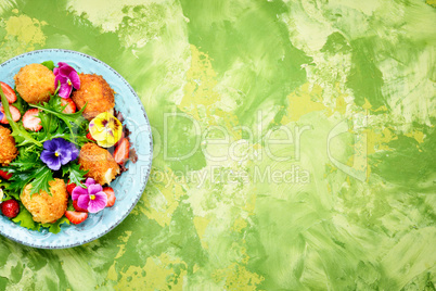 Salad leaves with strawberries,herbs and flowers