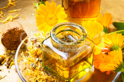 Medicine bottle and herbs calendula