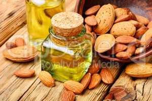 Almond oil in bottle and nuts