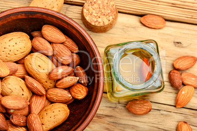 Almond oil in bottle and nuts