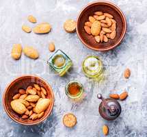 Almond oil in bottle and nuts