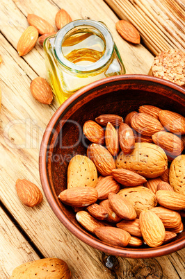 Almond oil in bottle and nuts