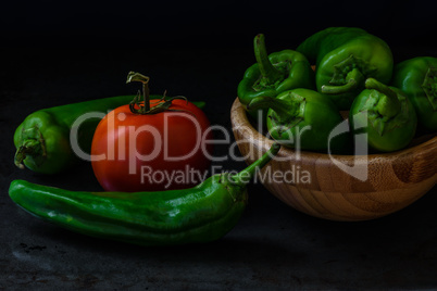 chili pepper and tomato on dark background
