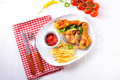 Grilled chicken wings,legs,chips and vegetables