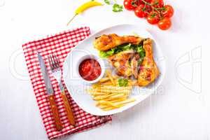 Grilled chicken wings,legs,chips and vegetables