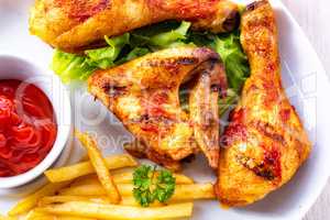 Grilled chicken wings,legs,chips and vegetables