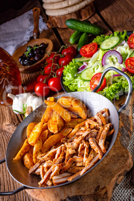 Rustic gyros plate it green salad and potato wedges