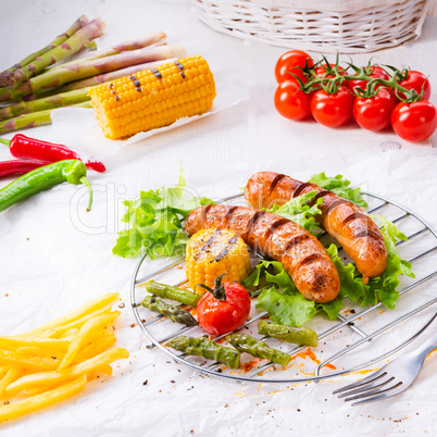 grilled krakauer sausage with boiled corn and green salad