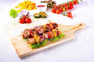 tasty and colorful meat skewers with peppers and onions
