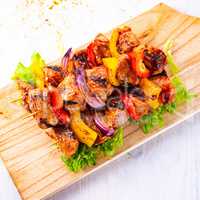 tasty and colorful meat skewers with peppers and onions