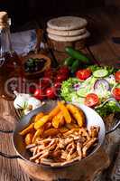 Rustic gyros plate it green salad and potato wedges