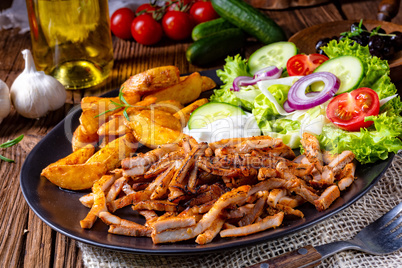 Rustic gyros plate it green salad and potato wedges