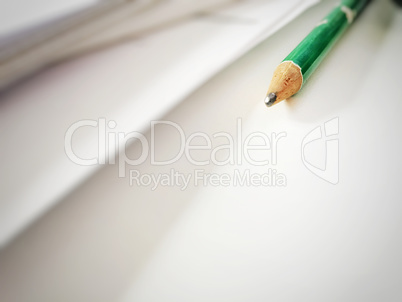 Green pencil on a white desk
