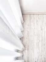 Wooden parquet floor with white curtains
