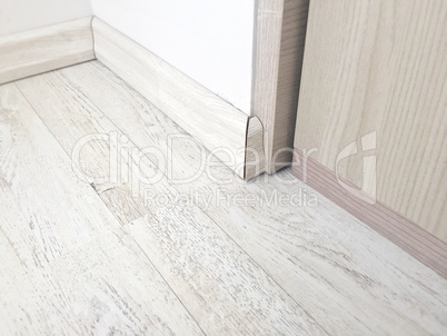 Wooden floor parquet with wooden baseboard