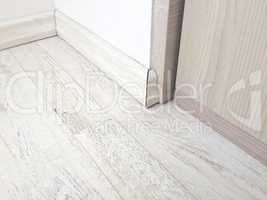 Wooden floor parquet with wooden baseboard