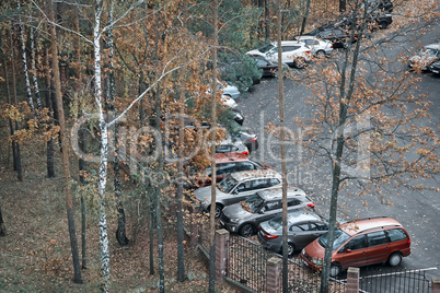 Cars parked near the fence of the Park.