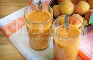 Apricot smoothie with yogurt in glasses.
