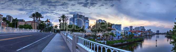 Sunset over the colorful shops of the Village on Venetian Bay