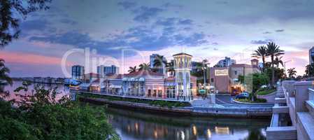 Sunset over the colorful shops of the Village on Venetian Bay