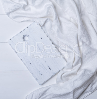 rectangular white cutting board on white textile tablecloth