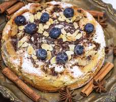 baked round cake with blueberries