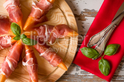 Close up of Italian appetizer with prosciutto and melon
