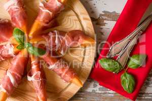 Close up of Italian appetizer with prosciutto and melon