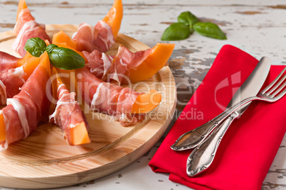 Cutting board with prosciutto and melon