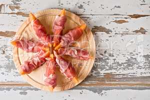 Italian food with prosciutto and melon