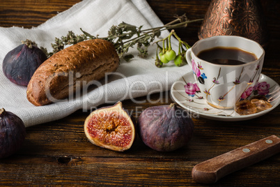Light breakfast with coffee, bun and few figs.